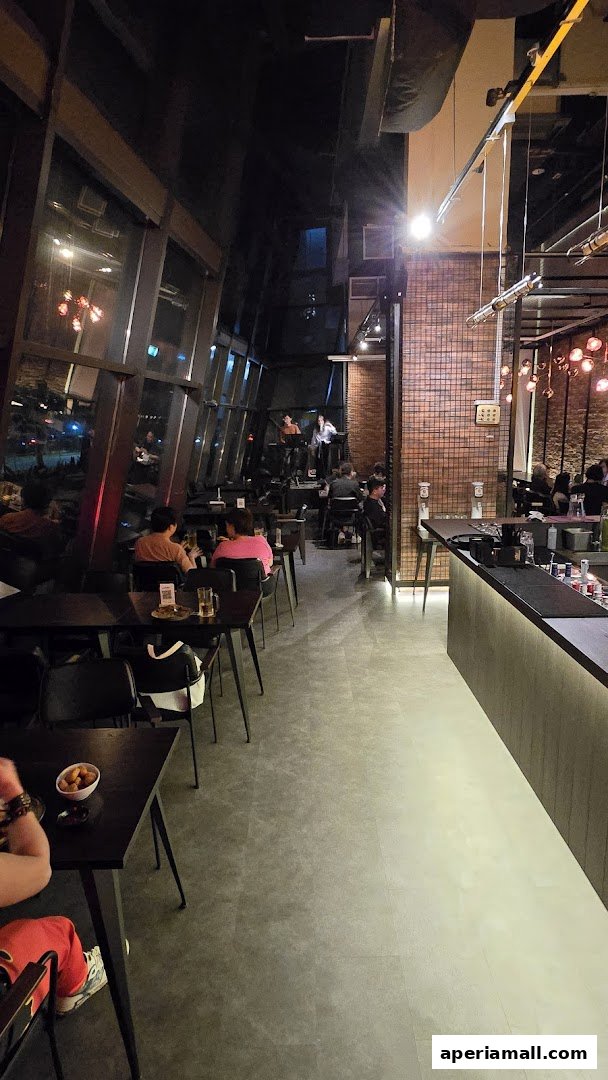 Interior view of a restaurant with a live band performing and patrons seated at tables.