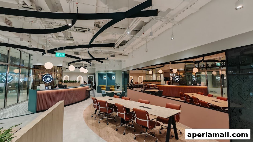 Modern office interior with a reception desk, meeting tables, and lounge areas.