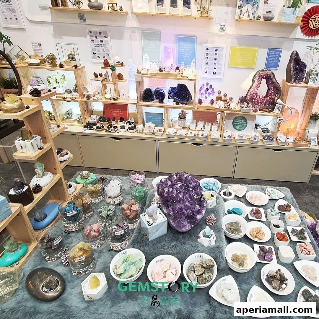 A shop interior displaying a wide variety of crystals and gemstones on shelves and tables.