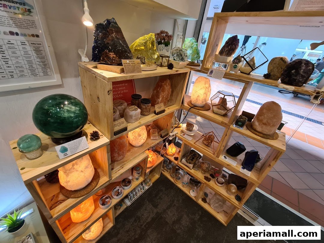 A retail display featuring various crystals, salt lamps, and decorative items on wooden shelves.