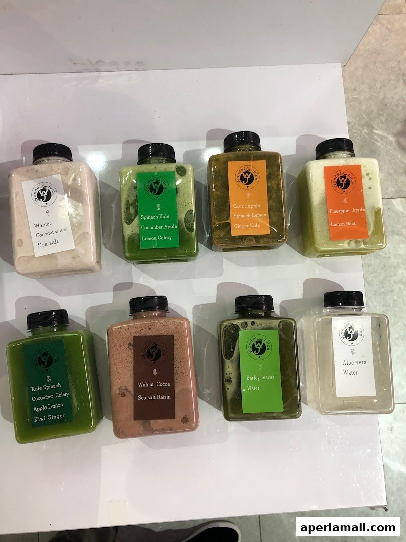 Eight bottles of fresh juices and drinks from Wonder Juice, each with a label indicating its ingredients.