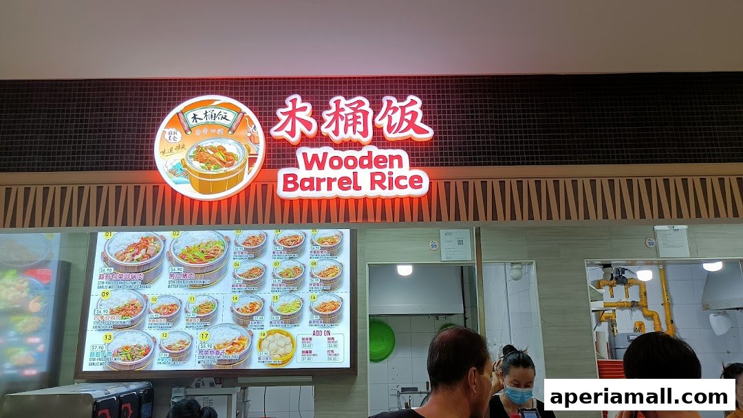 The illuminated sign for 'Wooden Barrel Rice' with a menu display below.