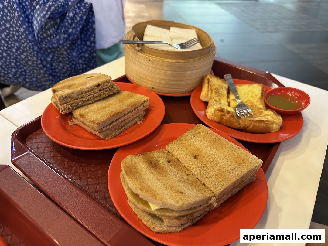 A tray of Ya Kun Kaya Toast with kaya toast, butter toast, and soft-boiled eggs.