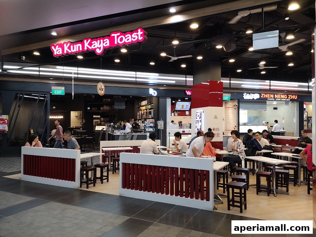 Interior view of Ya Kun Kaya Toast with customers seated at tables.