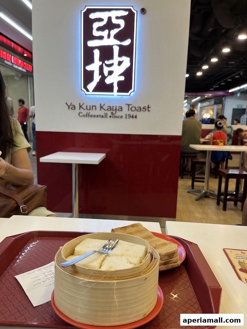 A close-up of steamed kaya toast and butter toast served on a tray at Ya Kun Kaya Toast.