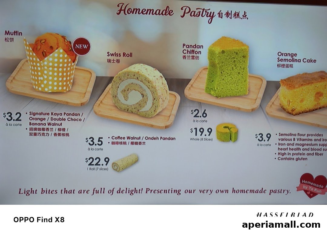A display of homemade pastries including muffins, Swiss rolls, chiffon cake, and semolina cake with prices.