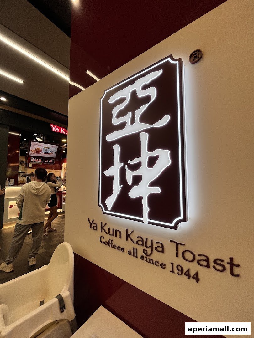 The illuminated logo of Ya Kun Kaya Toast with the tagline 'Coffees all since 1944'.