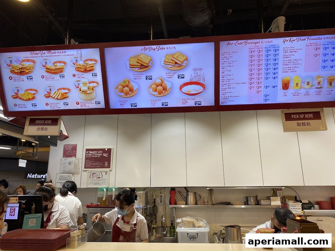 A menu board displaying various set meals, all-day sides, and beverages at Ya Kun Kaya Toast.