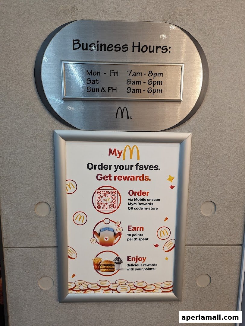 McDonald's business hours and rewards program information displayed on a wall.